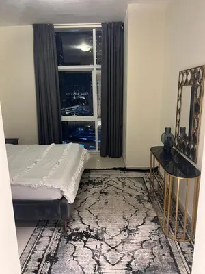 a bedroom with a bed and a window at Spacious Flat in Dubai Downtown in Dubai