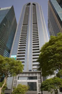 a tall building with a sign on the bottom of it at Spacious Flat in Dubai Downtown in Dubai