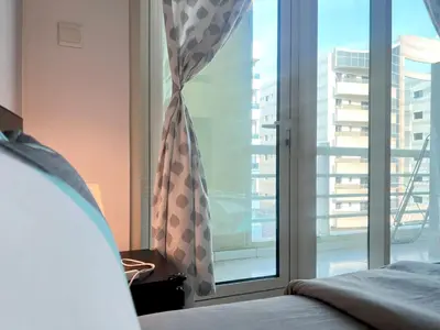 a bedroom with a window with a view of a building at Huge Room in Al Barsha 1 Near Mashreq Metro in Dubai