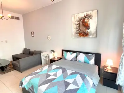 a bedroom with a bed and a painting of a horse at Huge Room in Al Barsha 1 Near Mashreq Metro in Dubai