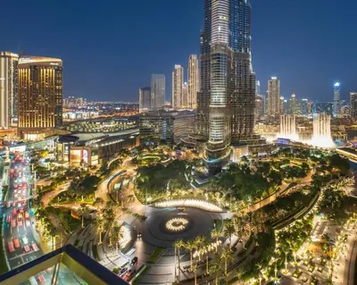 a view of a city at night with tall buildings at FIRST CLASS 3BR with full BURJ KHALIFA and FOUNTAIN VIEW in Dubai