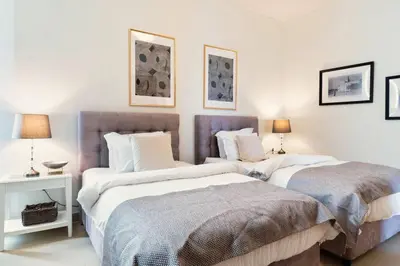 two beds sitting next to each other in a bedroom at FIRST CLASS 3BR with full BURJ KHALIFA and FOUNTAIN VIEW in Dubai