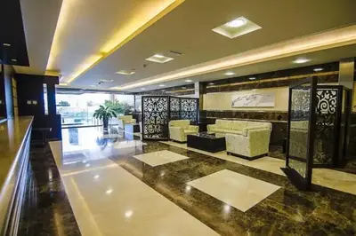a living room with a lobby with a couch and tables at Stunning 1 BR Apartment in Dubai Marina in Dubai