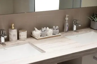 a bathroom counter with two sinks and a mirror at Magnificent Cozy 2BR in Downtown Dubai in Dubai