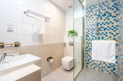 a bathroom with a toilet and a sink and a shower at GuestReady - Glamourous living in Palm Jumeirah in Dubai