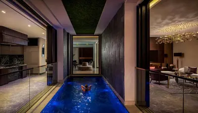 a swimming pool in the middle of a house at The Biltmore Hotel Villas, Dubai in Dubai