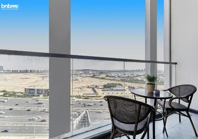 a table and chairs in a room with a view of a city at bnbmehomes - Bayz by Danube in Dubai