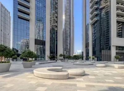 a courtyard in a city with tall buildings at Burj Khalifa view - Modern 1BDR apartment in Dubai