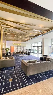 a lobby with couches and tables in a building at Best Offer in Dubai hotel apartment damac hills 2 in Dubai