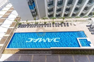 a swimming pool in front of a building at Best Offer in Dubai hotel apartment damac hills 2 in Dubai