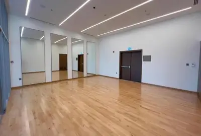 an empty room with a wooden floor and white walls at Modern 1 BR with Sea View - Minutes to Dubai Mall, Downtown Dubai in Dubai