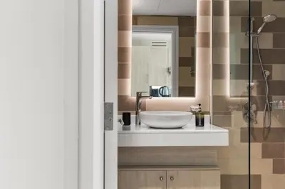 a bathroom with a sink and a mirror at Modern Fully-Equipped Apartment in Seven Palm, Beach and Pool Access in Dubai