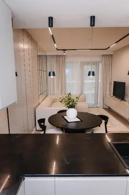 a living room with a table and a couch at Modern Fully-Equipped Apartment in Seven Palm, Beach and Pool Access in Dubai
