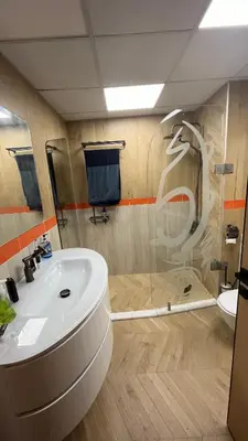 a bathroom with a white sink and a shower at AMWAJ JBR Walk Beachfront Apt in Dubai