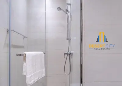 a bathroom with a shower with a glass door at Azizi Riviera 7 - Meydan City, Dubai in Dubai