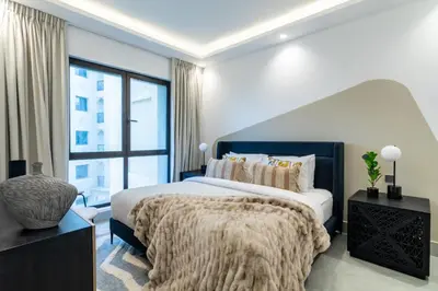 a bedroom with a large bed and a large window at The Smart Concierge - Reehan 8 in Dubai