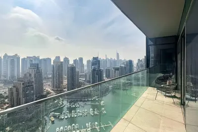 a glass balcony with a view of a city at 1BDR in Marina Gate Skylineview in Dubai