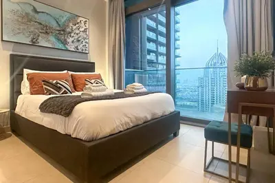 a bedroom with a bed and a large window at 1BDR in Marina Gate Skylineview in Dubai
