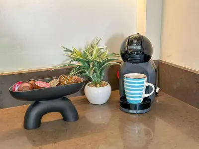 a coffee maker and a bowl of bread and a cup of coffee at 1BDR in Marina Gate Skylineview in Dubai