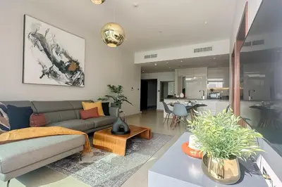a living room with a couch and a table at 1BDR in Marina Gate Skylineview in Dubai
