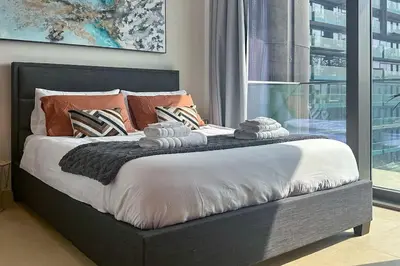 a bedroom with a large bed with towels on it at 1BDR in Marina Gate Skylineview in Dubai