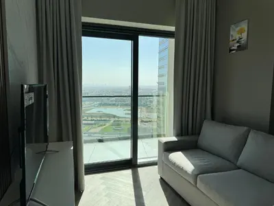 a living room with a couch and a large window at Zada Tower , near to Burj Khalifa NYE fireworks in Dubai