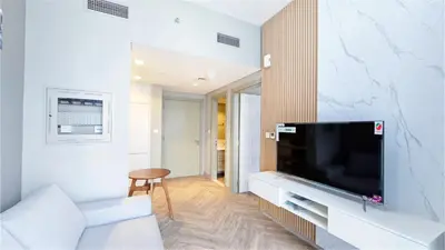 a living room with a flat screen tv on a wall at Zada Tower , near to Burj Khalifa NYE fireworks in Dubai