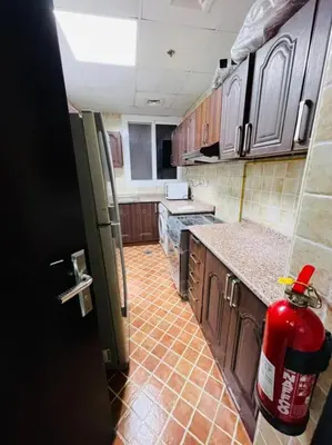 a kitchen with a fire hydrant in the middle of it at Wow Partition Room In Barsha 1 Near MOE Metro in Dubai