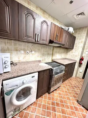 a kitchen with a washer and dryer in it at Wow Partition Room In Barsha 1 Near MOE Metro in Dubai