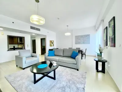 a living room with a couch and a table at JBR Beach Full Sea View 2 BR High Floor in Dubai