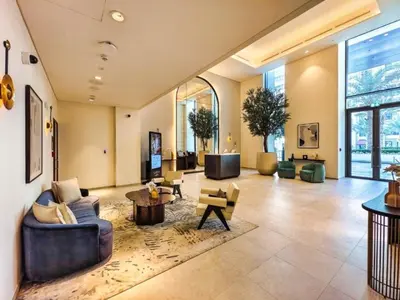 a large living room with couches and tables at Luxury 1BR Retreat @ Vida Residences - Creek Beach in Dubai