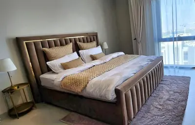 a bedroom with a large bed with pillows at Luxury 1BR Retreat @ Vida Residences - Creek Beach in Dubai