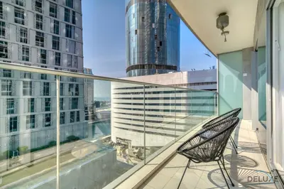 a chair on a balcony with a view of a city at Wondrous 1BR at DAMAC Heights Dubai Marina by Deluxe Holiday Homes in Dubai