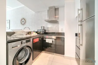 a kitchen with a washer and dryer in it at Wondrous 1BR at DAMAC Heights Dubai Marina by Deluxe Holiday Homes in Dubai