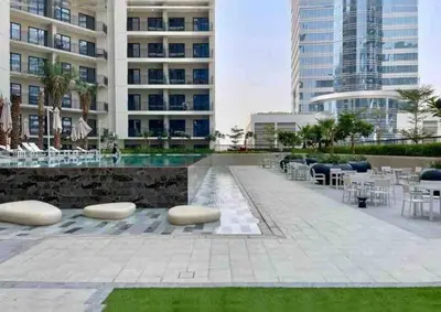 a courtyard with chairs and tables and a building at Near Burj Khalifa NYE Brand New Cozy 1BR Business Bay in Dubai