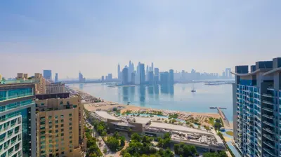 a view of a city with a river and buildings at Studio with pool and private beach access on Palm Jumeirah in Dubai