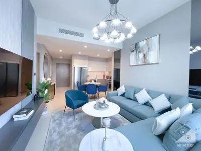 a living room with a blue couch and a table at Luxury Burj Royale Apt balcony & Breathtaking View in Dubai