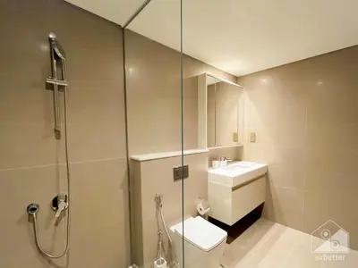 a bathroom with a shower and a toilet and a sink at Luxury Burj Royale Apt balcony & Breathtaking View in Dubai