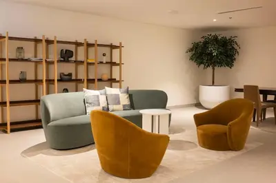 a living room with a couch and two chairs and a table at Brand new 2 BR in Boulevard with partial Burj Khalifa and Opera View in Dubai