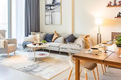 a living room with a couch and a table at Brand new 2 BR in Boulevard with partial Burj Khalifa and Opera View in Dubai