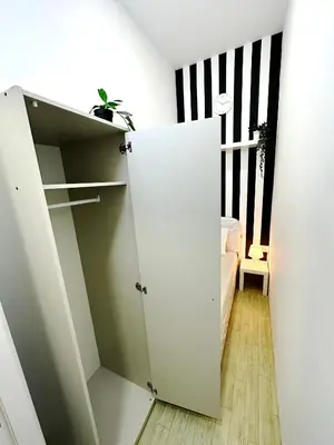 a closet with a white door in a room at Striped Partition Room in Barsha 1 Near Mall of the Emirates in Dubai