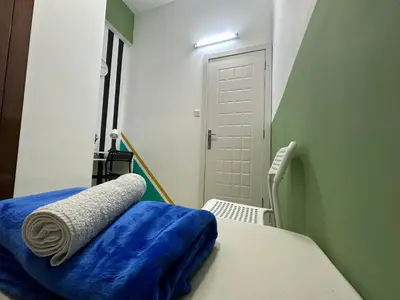 a hospital room with a bed with a blue blanket at Spacious Mini Partition Room Near Emirates Mall in Dubai