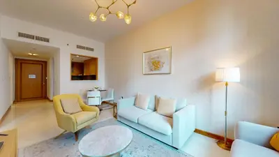 a living room with a couch and chairs and a table at Iris Blue - Neat One Bedroom in Dubai