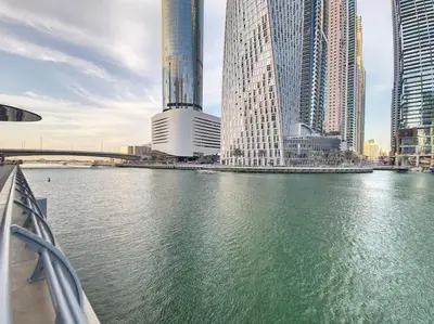 a view of a river in a city with tall buildings at Iris Blue - Neat One Bedroom in Dubai