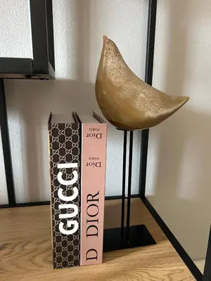 a book and a shoe sitting next to a book at SmartApt Elegant 1 BDR Burj view in Dubai