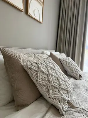 a bed with a white blanket and pillows on it at SmartApt Elegant 1 BDR Burj view in Dubai