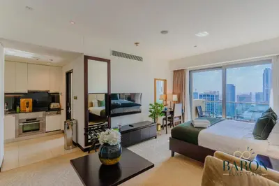 a hotel room with a bed and a large window at The Stylish in Dubai