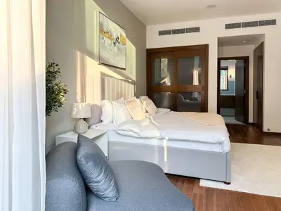a bedroom with a bed and a couch at Upgraded 1BR Paradise With Private Garden - Oceana in Dubai