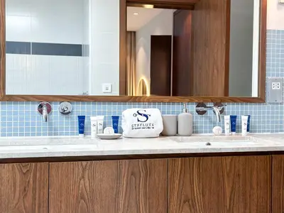 a bathroom with a sink and a mirror at Upgraded 1BR Paradise With Private Garden - Oceana in Dubai
