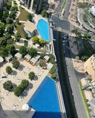 an aerial view of a city with a swimming pool at Address Fountain View Tower 2 in Dubai
